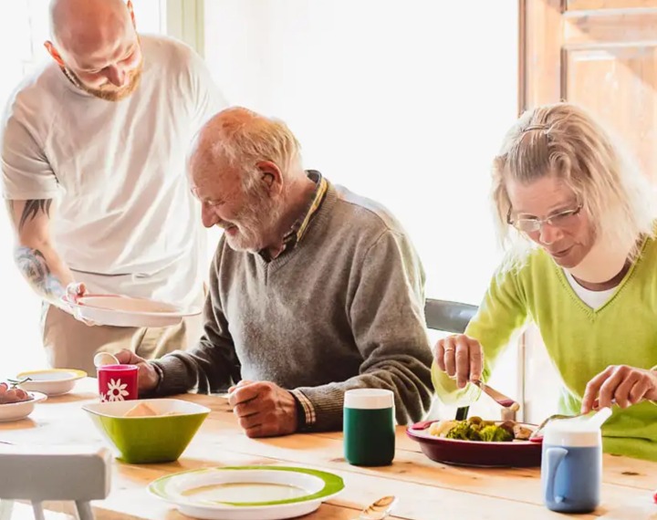 Seniors eating at table with melamine crockery